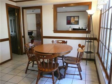 Spacious eat-in breakfast area has large picture w