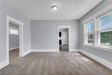 Unfurnished bedroom featuring multiple windows, carpet floors, and a textured ceiling