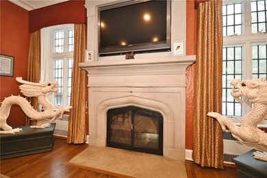 Stone fireplace is flanked by leaded glass floor t