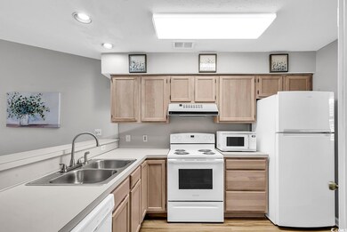 Kitchen featuring light brown cabinets, light wood