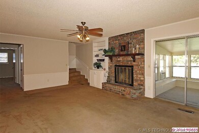 The family room has built in bookshelves and a bri