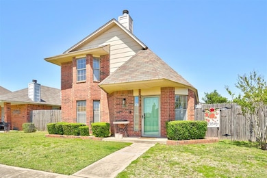 Traditional home with fence, a front lawn, brick s