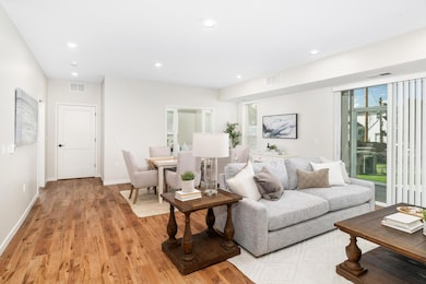 The large living room is bathed in natural light, offering flexible layout options and direct access to a screened-in maintenance-free deck, where you can relax and enjoy the outdoors in comfort year-round.