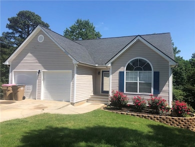 Ranch-style house with an attached garage, roof wi