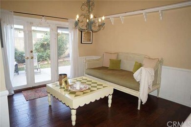 Home has three areas to entertain and relax. This is in the kitchen with access to a side patio. White Wainscoting adds an architectural twist to this charming room.  