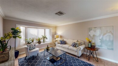 Living room front of home with crown molding, tile