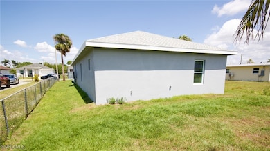 View of side of property with a shingled roof, stu