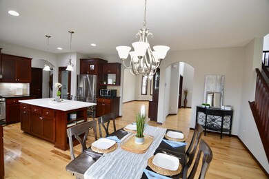 Another angle of the kitchen towards the open two-story foyer.