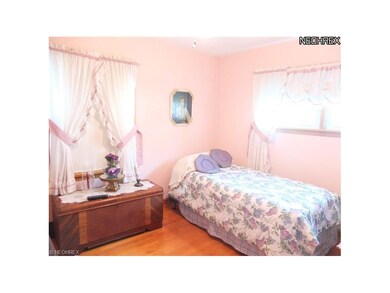 Bedroom 2 with hardwood floors.