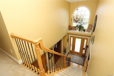 Grand 2 story foyer with wrought iron details.