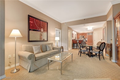 Living room with crown molding and light carpet