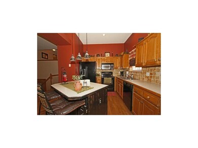 Large Kitchen with hardwood floor, pantry, island 