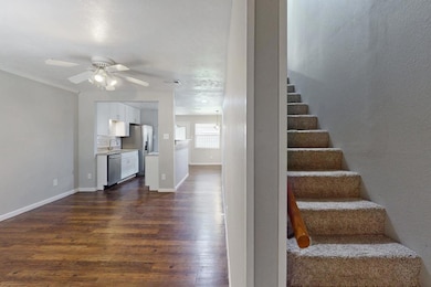 Stairs featuring wood finished floors, a ceiling f