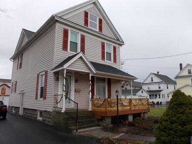 West side of home with driveway leading to a 2+ ca