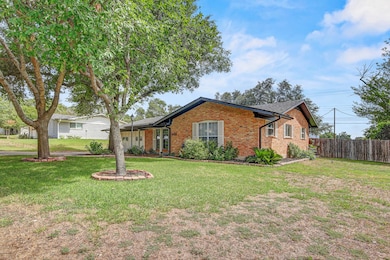 Single story home with brick siding and a shingle
