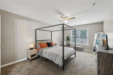 Owner's Suite featuring carpet, baseboards, and ceiling fan