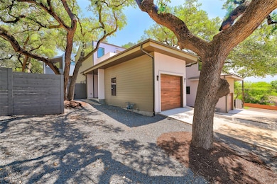 View of side of property with a garage and drivew