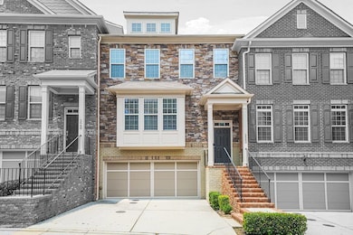 Multi unit property featuring a garage, concrete driveway, and stairway