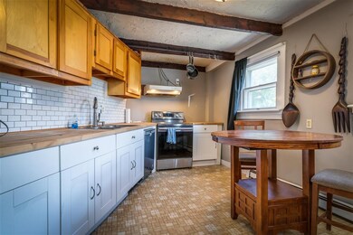Updated lower cabinets, butcher-block counters, ti
