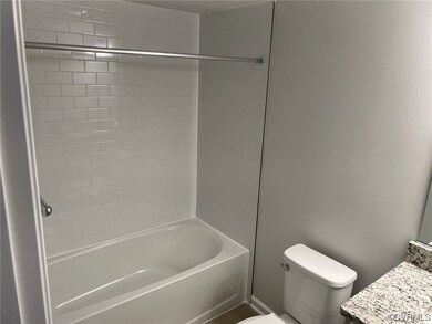 Full bathroom featuring tiled shower / bath and vanity