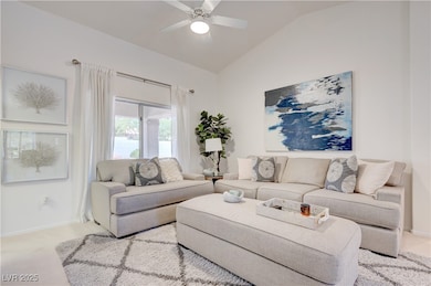 Living area with lofted ceiling, light carpet, a c
