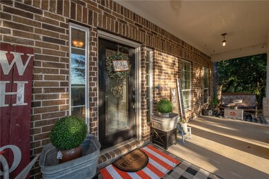 Doorway to property featuring a covered porch