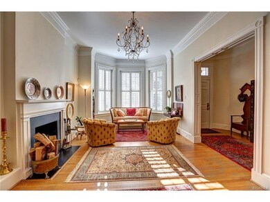 Double Parlor Living Room with 2 fireplaces and 2 chandeliers.