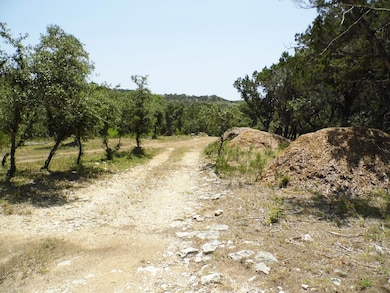 View of dirt / gravel road with a rural view