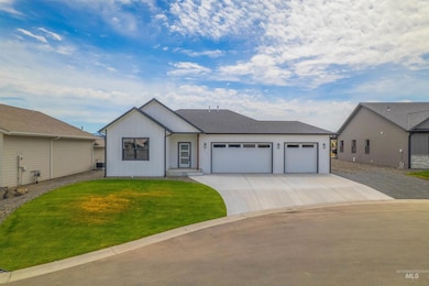 View of front facade featuring concrete driveway, a garage, and a front lawn