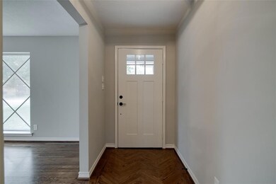 Entry with herringbone wood floor design.