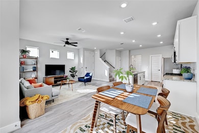 Dining room with stairway, light wood-style floor