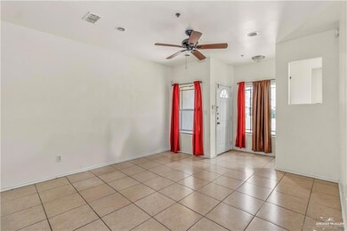 Unfurnished room with baseboards, a ceiling fan, and light tile patterned floors