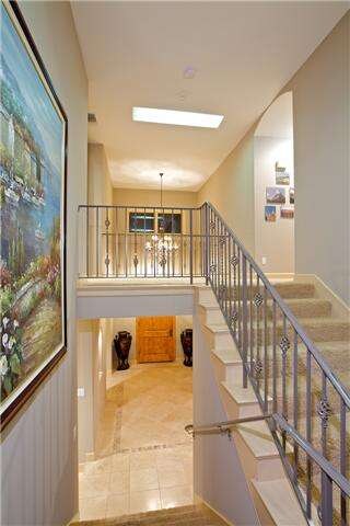 the formal entry below, night lit skylight above, welcome home!