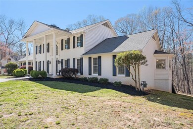 All brick home with a circular driveway on a woode