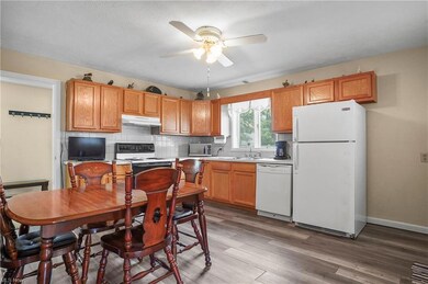 Kitchen featuring backsplash, brown cabinets, ligh