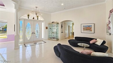 Foyer with ornamental molding, a chandelier, and o