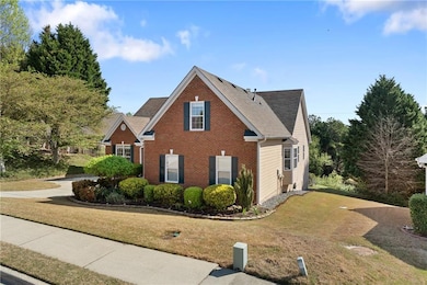 View of front of home with brick siding, roof with