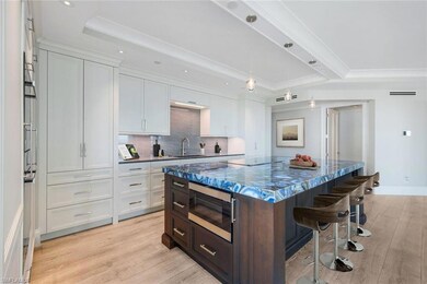 Virtually staged bar stools at large underlit Antolini Agate island.