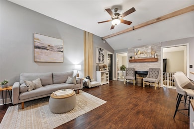 Living area with ceiling fan, wood finished floor