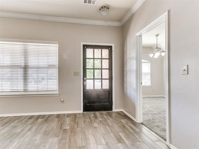 Entrance foyer featuring ceiling fan, visible vent