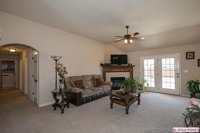 Living room with gas log fire place that will acco