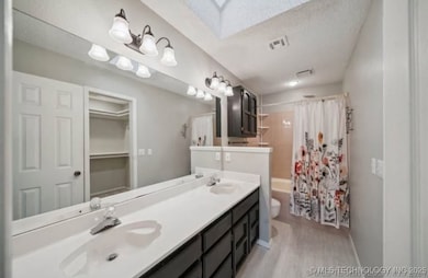 Bathroom with wood finished floors, toilet, shower