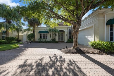 Mediterranean / spanish house featuring decorative driveway, a garage, and stucco siding