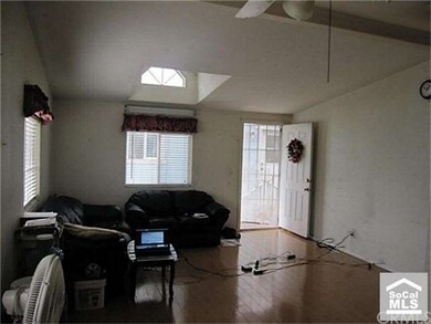 Living room with wood floor and vaulted ceiling