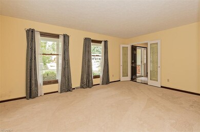 Carpeted Living Room is accessed off Foyer through