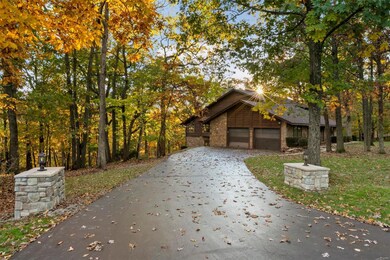 Side entry garage, long asphalt driveway to house 