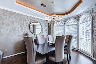 Very elegant formal dining room with coffered ceilings.
