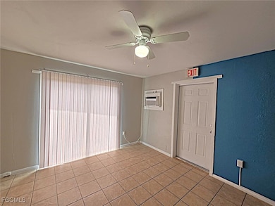 Unfurnished room with light tile patterned floors and a ceiling fan