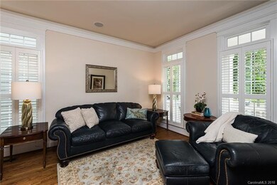 An handsome room with French doors just off the en