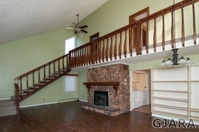 Hardwood Flooring In Living With Rock Fireplace